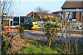 Train glimpsed through fence at Weston-super-Mare