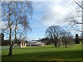 The ends of Acton Burnell tithe barn and modern college