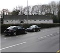 Row of houses behind a Grove Park hedge, Cwmbran