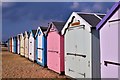 Beach huts alongside the beach.