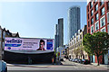 Looking up Wyvil Road, SW8, with advertisement