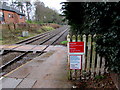 Bilingual notices on the approach to  Hawarden railway station level crossing, Flintshire