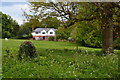 SU2845 : Field and house beside Thruxton Church by David Martin