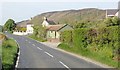 Houses and large corrugated iron shed on the B30 at Lislea