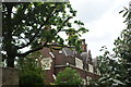 View of one of the almshouses through the trees on St. John