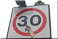 View of a sticker on a road sign at the end of Maple Road