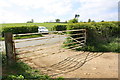 Gateway at end of footpath track giving access to road NW of Scalford