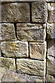 Benchmark on stones at junction of walls, Lower Clifton Street