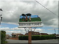 TF5209 : Marshland St. James village sign by Adrian S Pye