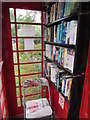 Chair and books inside a former red phonebox, Llanfrynach 