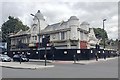 Former Temperance Billiard Hall behind a site fence, Lewisham High Street, London