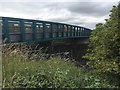 NX9930 : Footbridge over the A596 at Siddick  by Graham Hogg