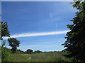 White band of cloud across a pale blue sky