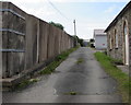 Side road past the edge of a fenced-off site, Pencader