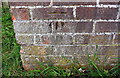 Benchmark on brick wall on south side of Trent Road