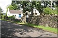 House, ornamental gate and OS Fundamental Bench Mark