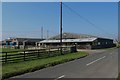 NZ2895 : Roadside barns at Hemscott Hill by Graham Robson