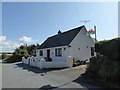 Cottage with the Welsh flag flying and selling plants