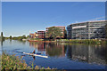 Sculling past new riverside flats