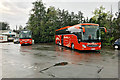 Two Orange Coaches outside Moffat Woollen Mill