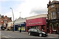 TQ2583 : Shops by Kilburn High Road Station by David Howard