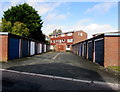 Electricity substation and flats behind two rows of lockup garages, Brickfields, Buckley