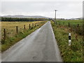 Minor fence-lined straight road heading in the direction of Kincraigie