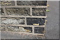 Benchmark on side wall (Tuel Lane face) of #1 Wallis Street