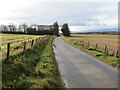 Fence-lined minor road approaching Burnside