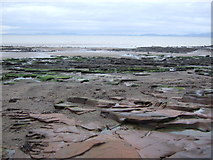 NY0337 : Rocks and beach near Maryport by JThomas