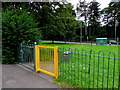 Yellow gate at the entrance to a green, Pengam