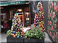 View of bauble Christmas trees outside The Ivy restaurant on Broadwick Street