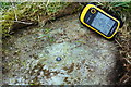 Benchmark and GPS unit on rock on west side of Great Close Lane