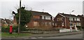 Boarded up house, well maintained garden