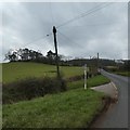 Side road and signpost at Chilton Gate on A3072