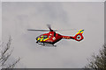 Air Ambulance flying over field adjacent to Flax Crescent, Carterton, Oxon