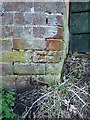 SO7598 : OS benchmark - Stableford, wall at corner of greenhouse by Richard Law