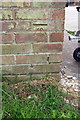 Benchmark on garage block on south side of Broadstone Court