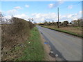 Hedge-lined Eccles Road near to Harling Farm