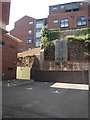 Old stone walls and modern buildings, off Coombe Street, Exeter