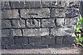 Benchmark on railway bridge wall on NE side High Street