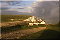 Coastguard Cottages at Cuckmere Haven with the Seven Sisters beyond in evening light