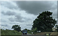 On the B3137, heading west, at the turning for West Middlewick Farm