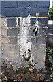 Benchmark on railway bridge pier in middle of Knighton Lane East