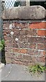 Damaged Benchmark on the wall of Clapham Lodge