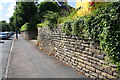 Toller Lane passing the wall in front of #1 Farfield Road