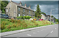 Houses and road above a grass bank, Thurlstone