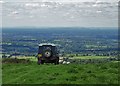 SJ9466 : Sheep farmer's Land Rover above The Cheshire Plain by Neil Theasby
