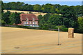 House overlooking field and haystack