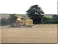 NZ2058 : Combine harvester at work by Oliver Dixon